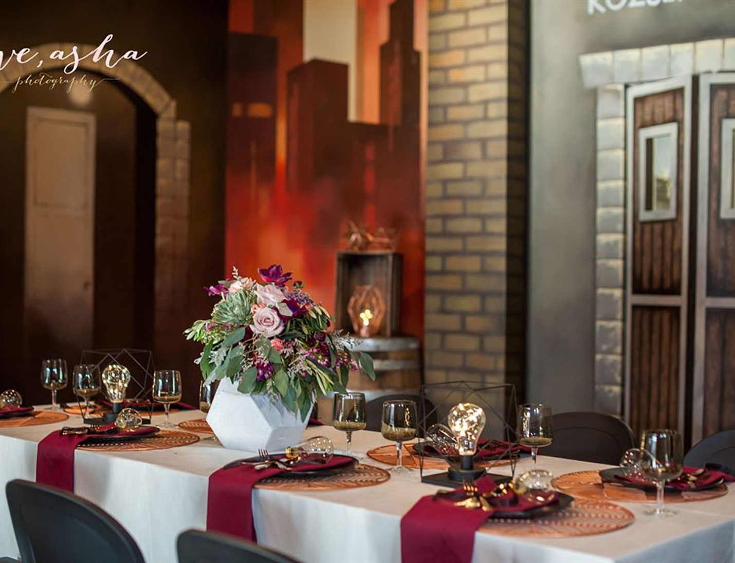 Elegant tablescape at Kozuba & Sons Distillery with floral centerpiece, modern glassware, and warm ambient lighting