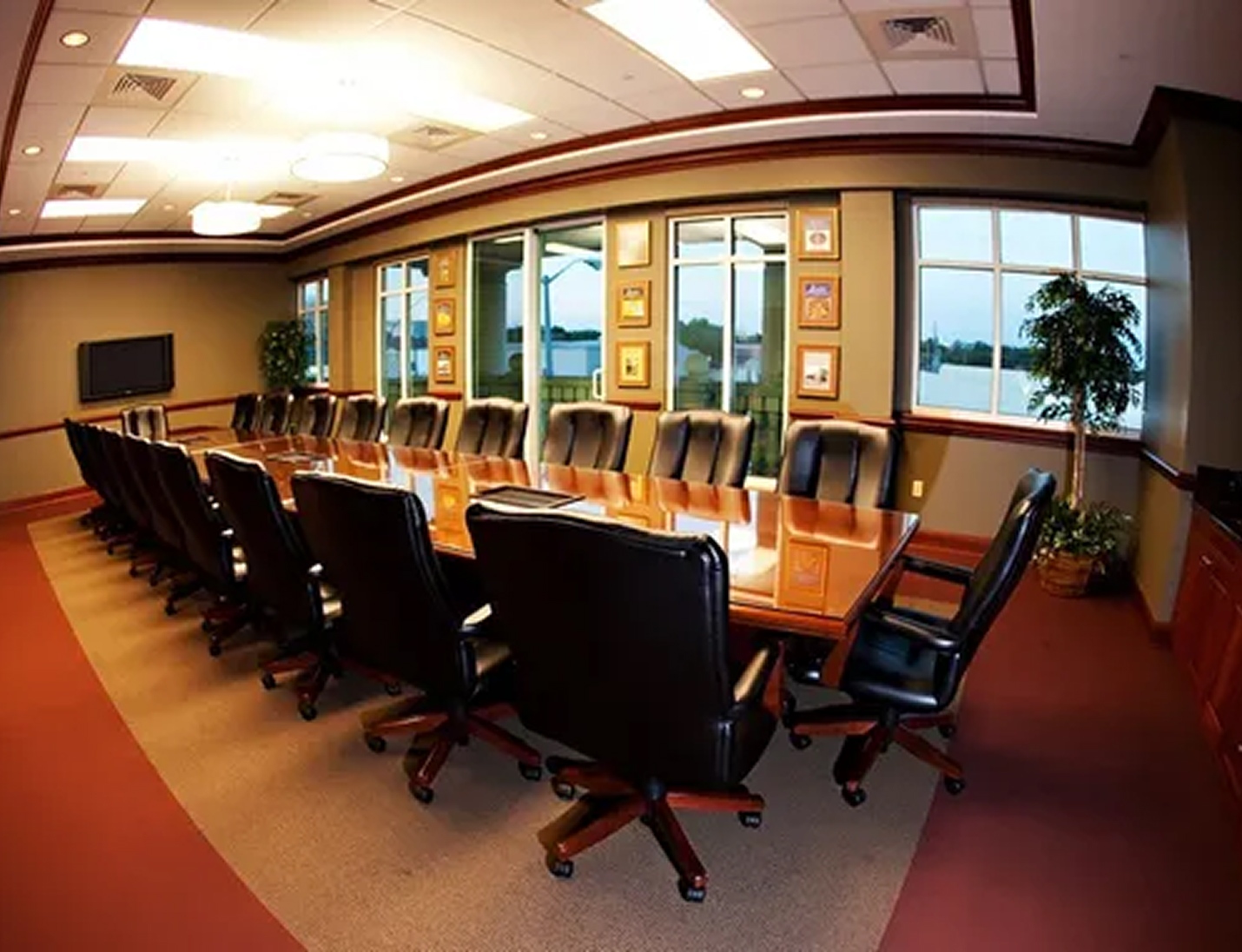 Conference room with a long meeting table, wall-mounted TV, and large windows at the Chester H Ferguson Law Center