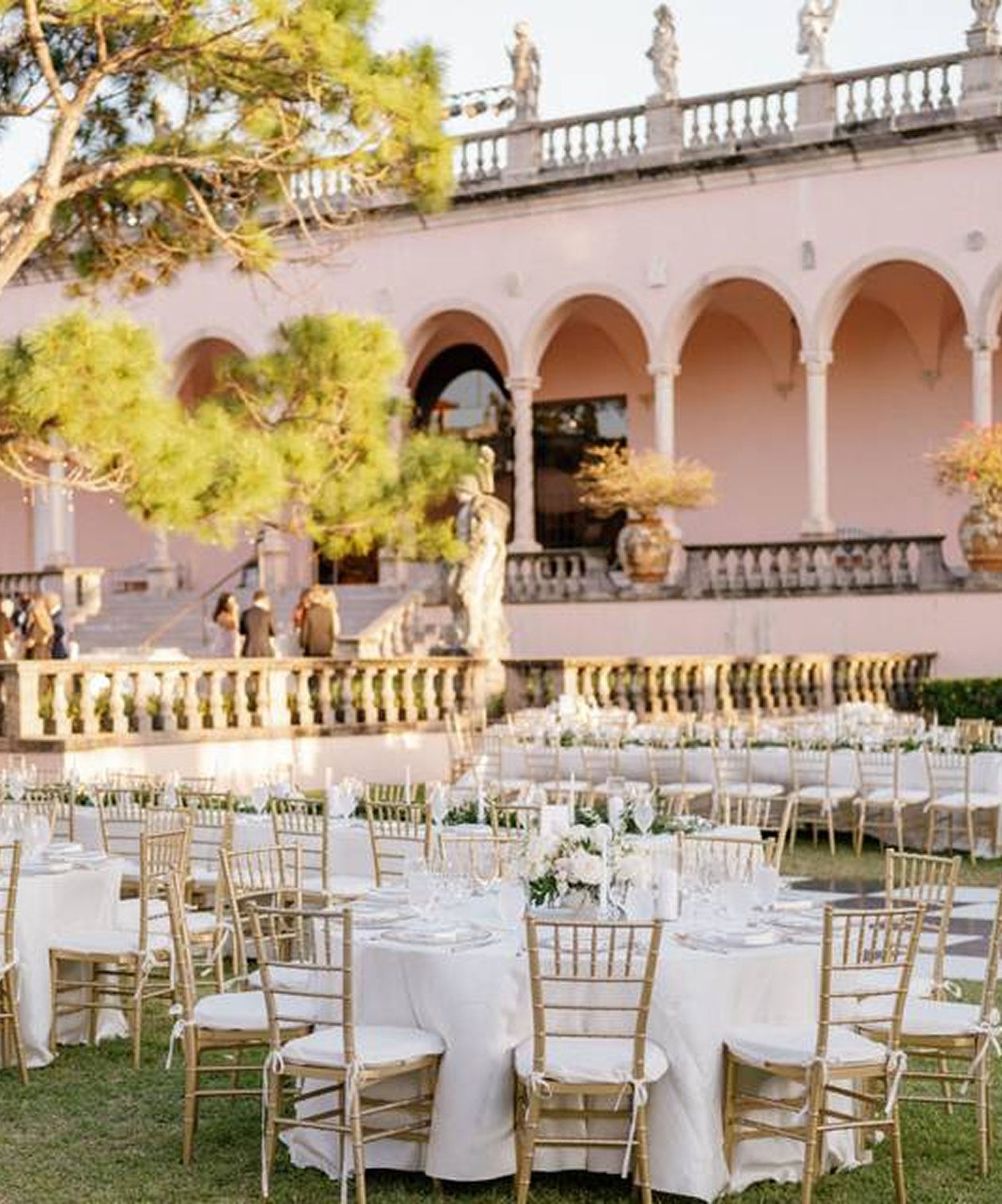 Wedding reception at The John and Mable Ringling Museum of Art with tables, white linens, and garden courtyard views