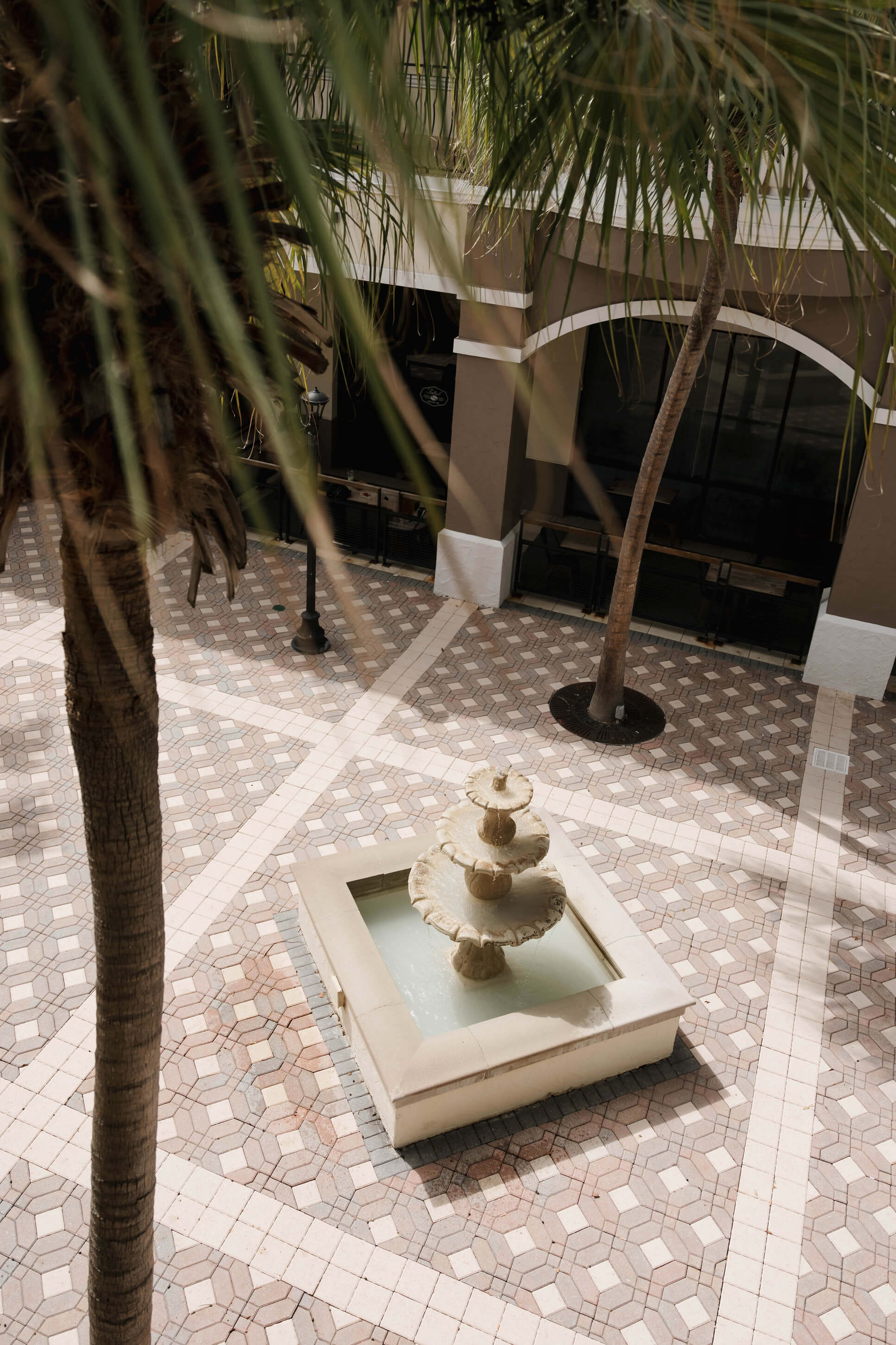 Trellis 925 indoor ceremony setup with white chairs, draped ceilings and string lights creating a warm atmosphere