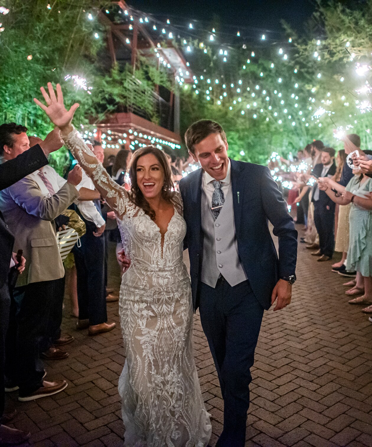 Bride and groom joyfully exit under sparkling lights at Nova 535, surrounded by cheering guests holding sparklers