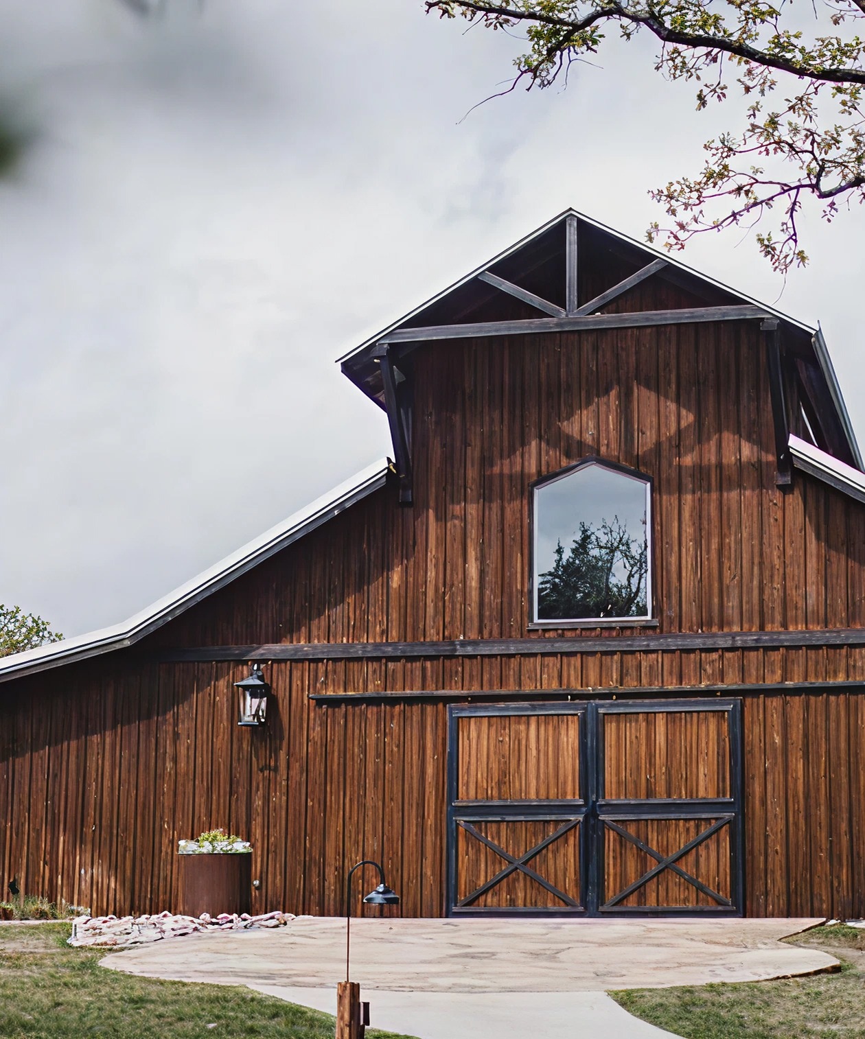 Rustic wooden barn exterior at Ever After Farms, featuring large double doors and natural countryside surroundings