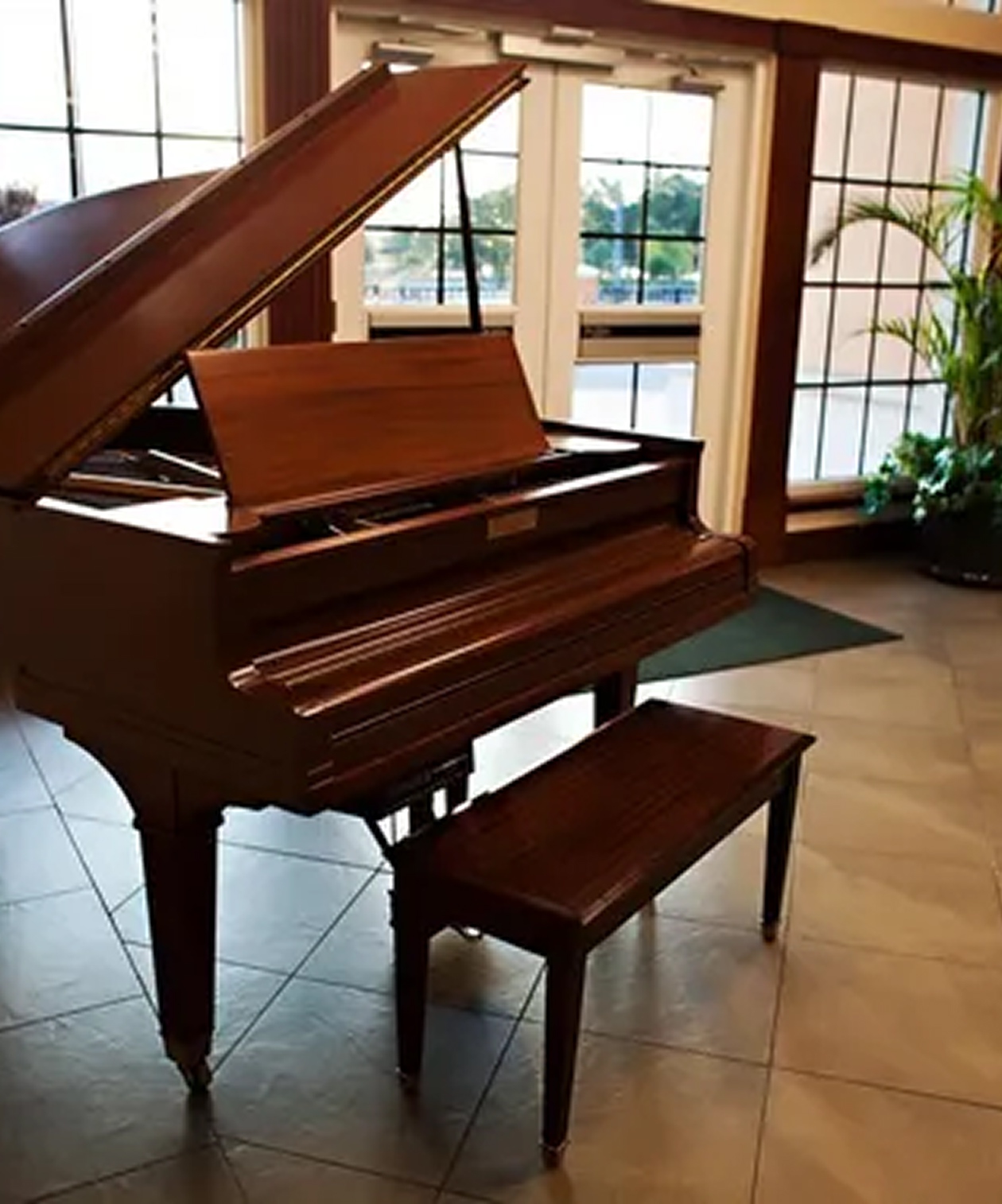 Grand piano displayed in the lobby of Chester H. Ferguson Law Center, surrounded by large windows and natural light
