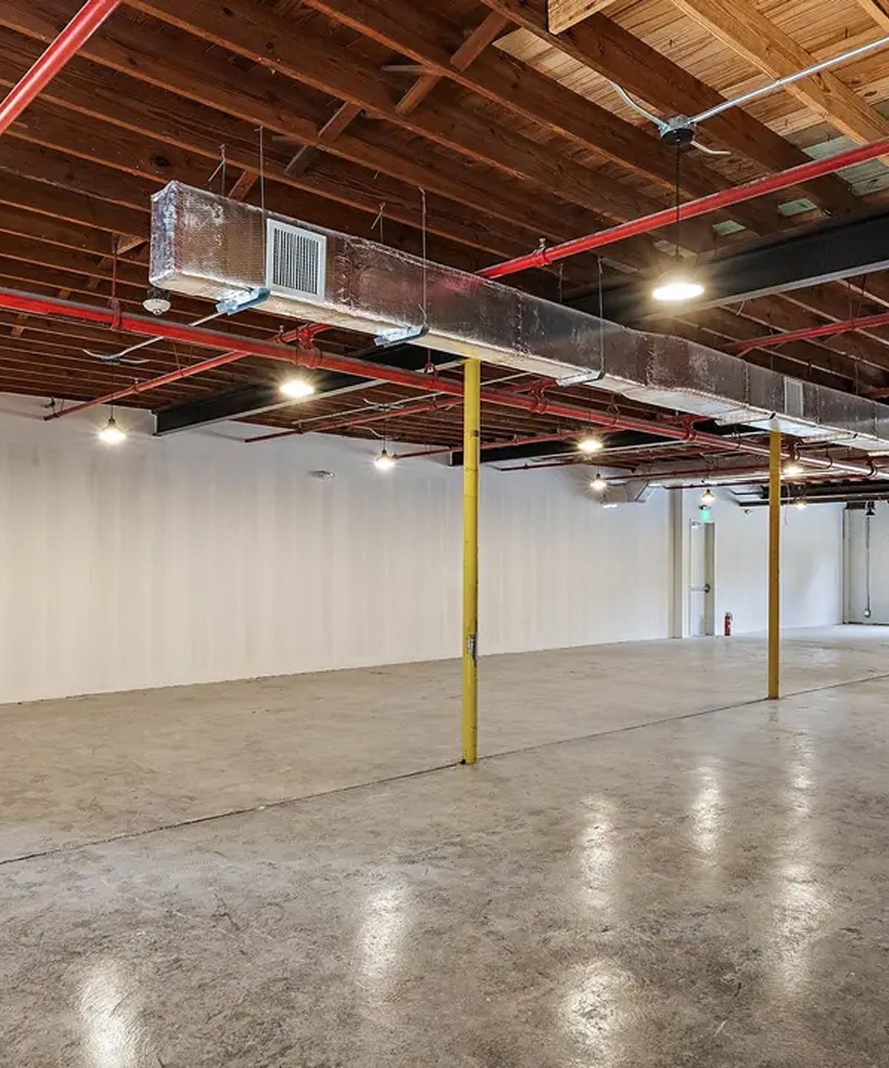 Open industrial event space at The Factory - St. Petersburg with concrete floors, exposed beams and high ceilings