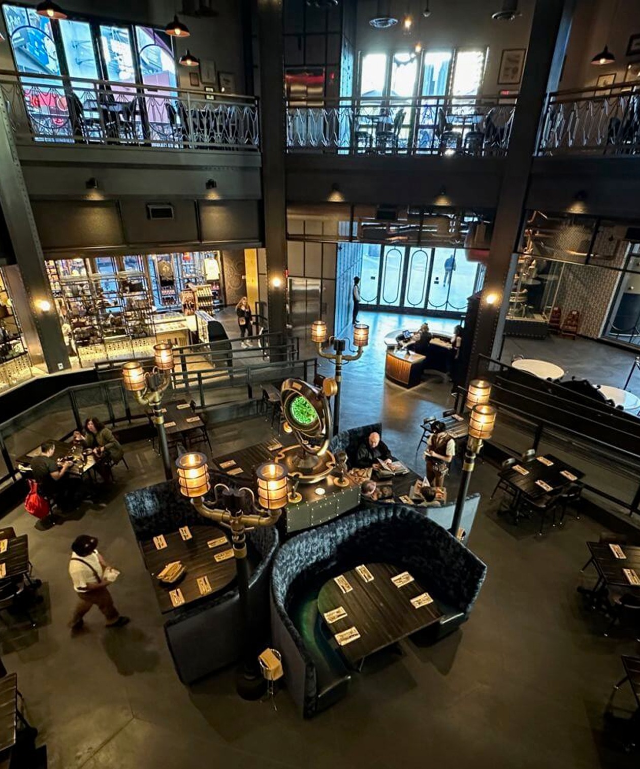 Industrial-style dining space at the Chocolate Factory with high ceilings, warm lighting and cozy booth seating
