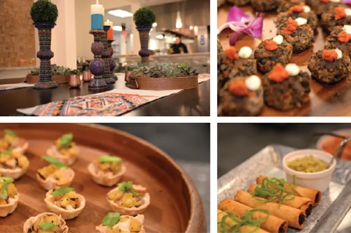 Colorful catering spread with mini appetizers, crispy rolls, and decorative candle centerpieces styled for a festive event