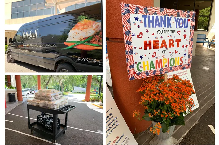 Catering delivery van and meal drop-off station with a handmade “Thank You, Heart of Champions” sign and bright flowers