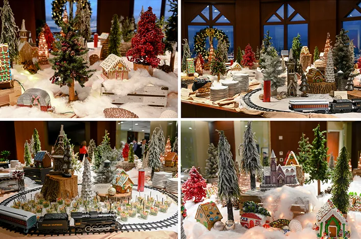 Holiday gingerbread village display with snowy decor, miniature houses, trees, and a toy train running through the scene