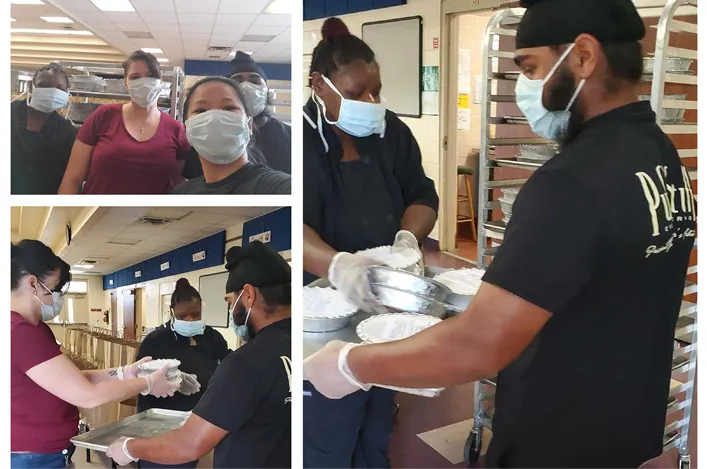 Puff ’n Stuff team members wearing masks and gloves collaborating to package and distribute meals inside a commercial kitchen